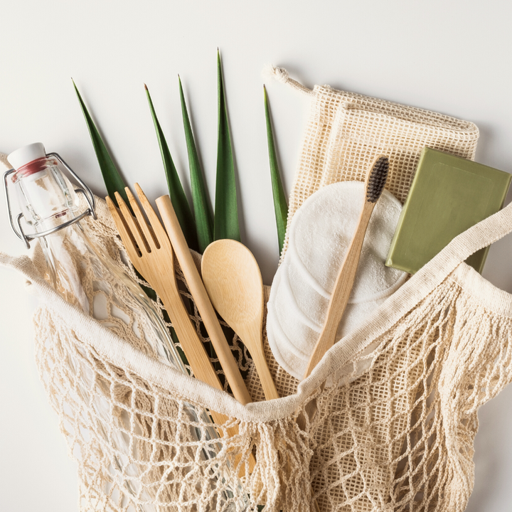 mesh bag laying down with bamboo products spilling out