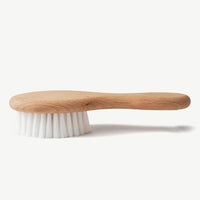 Baby hair brush made from bamboo laying face down