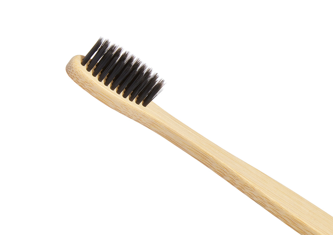 bamboo toothbrush close up on the black bristles 